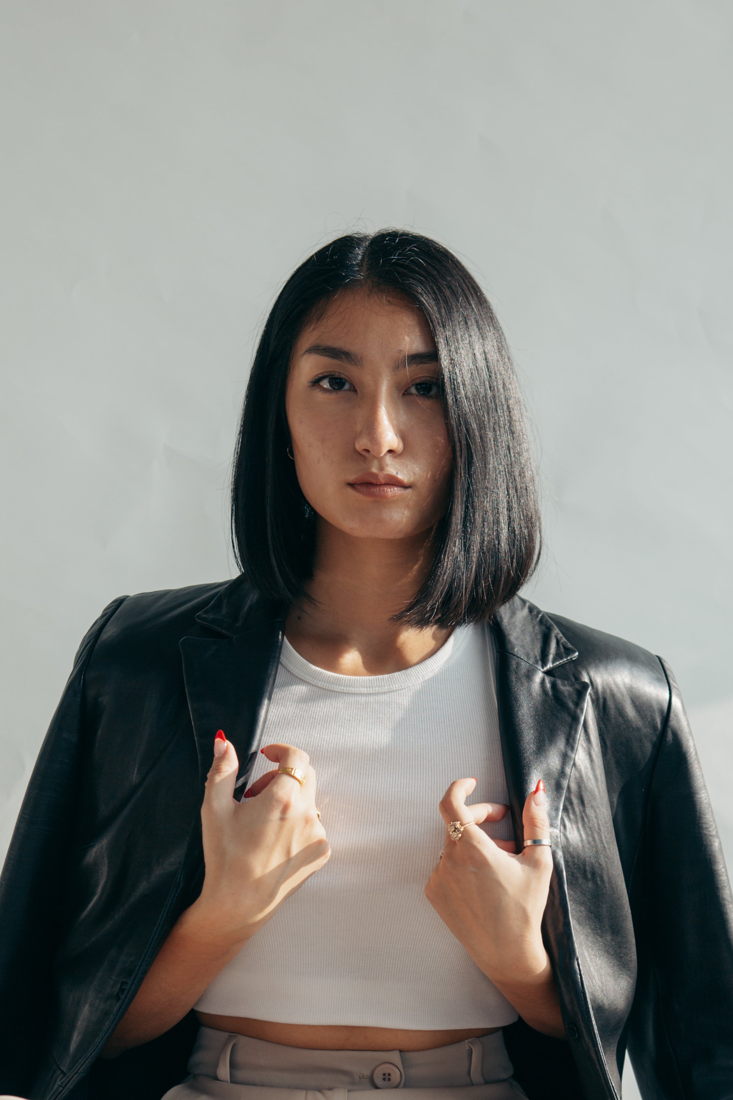 Woman with leather jacket over shoulders