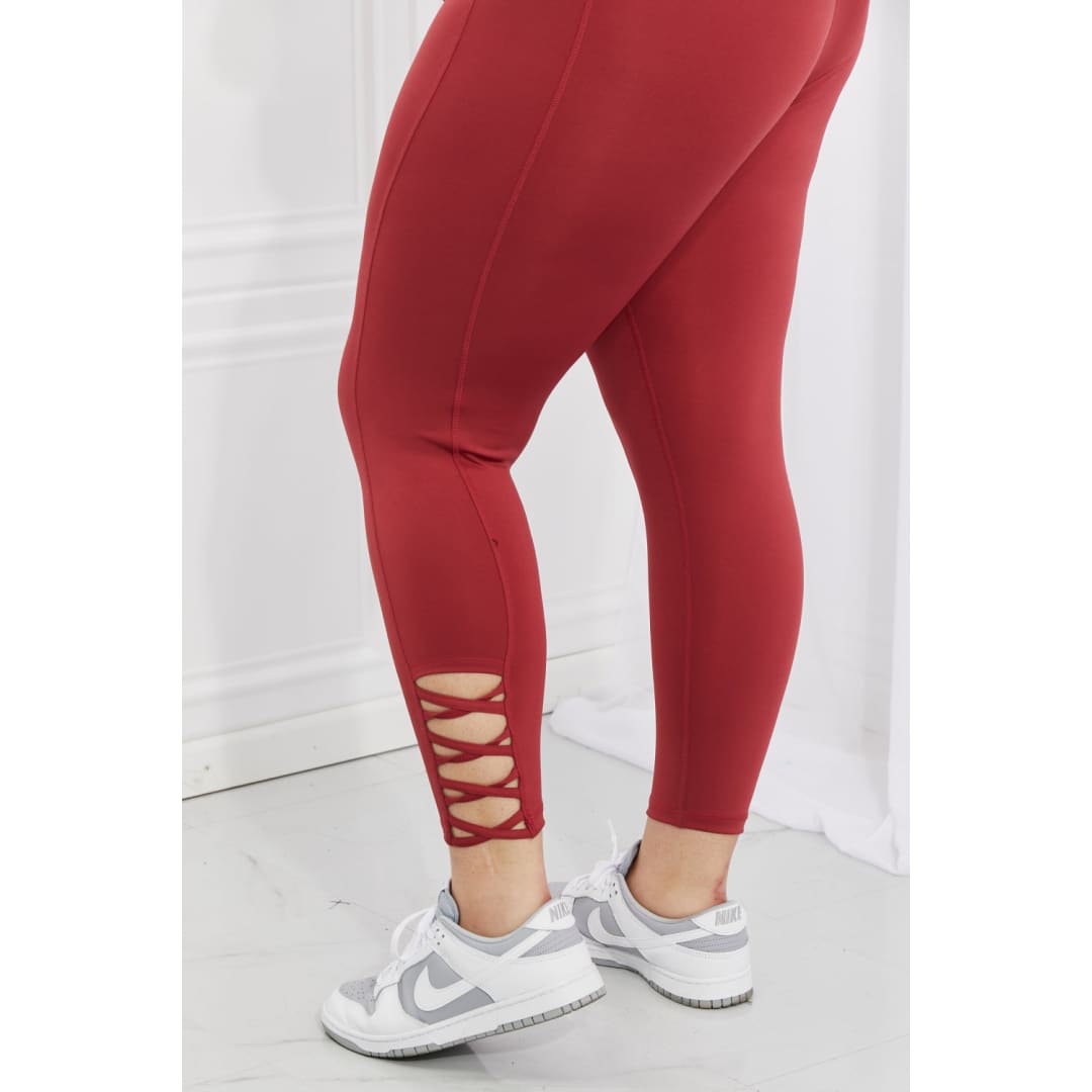 Yelete Ready For Action Full Size Ankle Cutout Active Leggings in Brick Red | The Urban